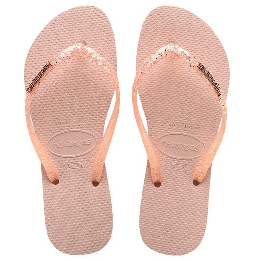 Pair of pink flip-flops with glittery straps on a white background