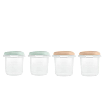 Four glass storage jars with various colored lids on a white background