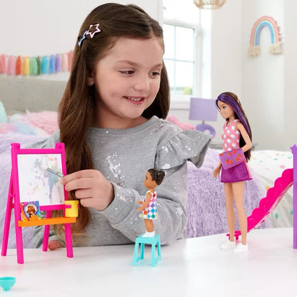 Young girl playing with Barbie dolls and furniture in a bedroom setting.