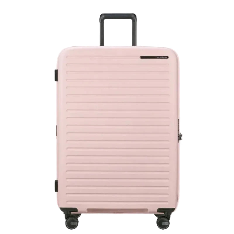 Pink suitcase with a textured surface on a white background