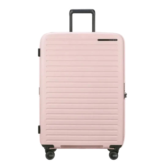 Pink suitcase with a textured surface on a white background