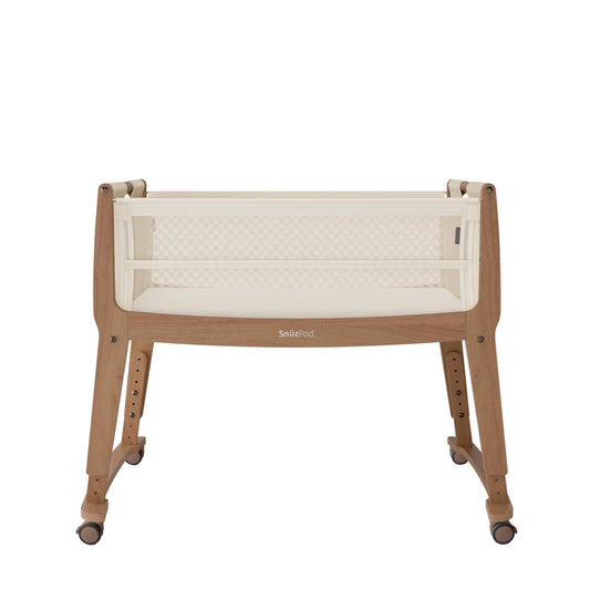 Baby crib with white mattress and wooden frame on a white background