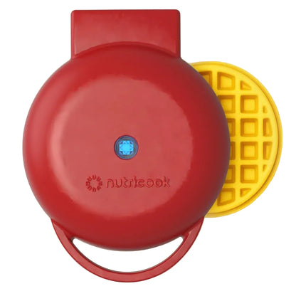Red waffle maker with a yellow waffle on a white background