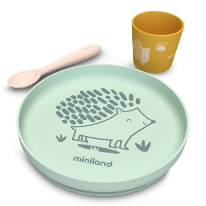 Children's dinner set with green plate, yellow cup, and wooden spoon on a white background
