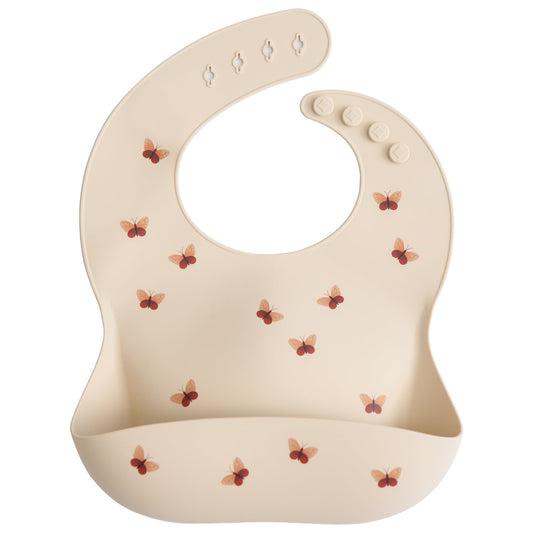 Beige baby bib with butterfly pattern on a white background